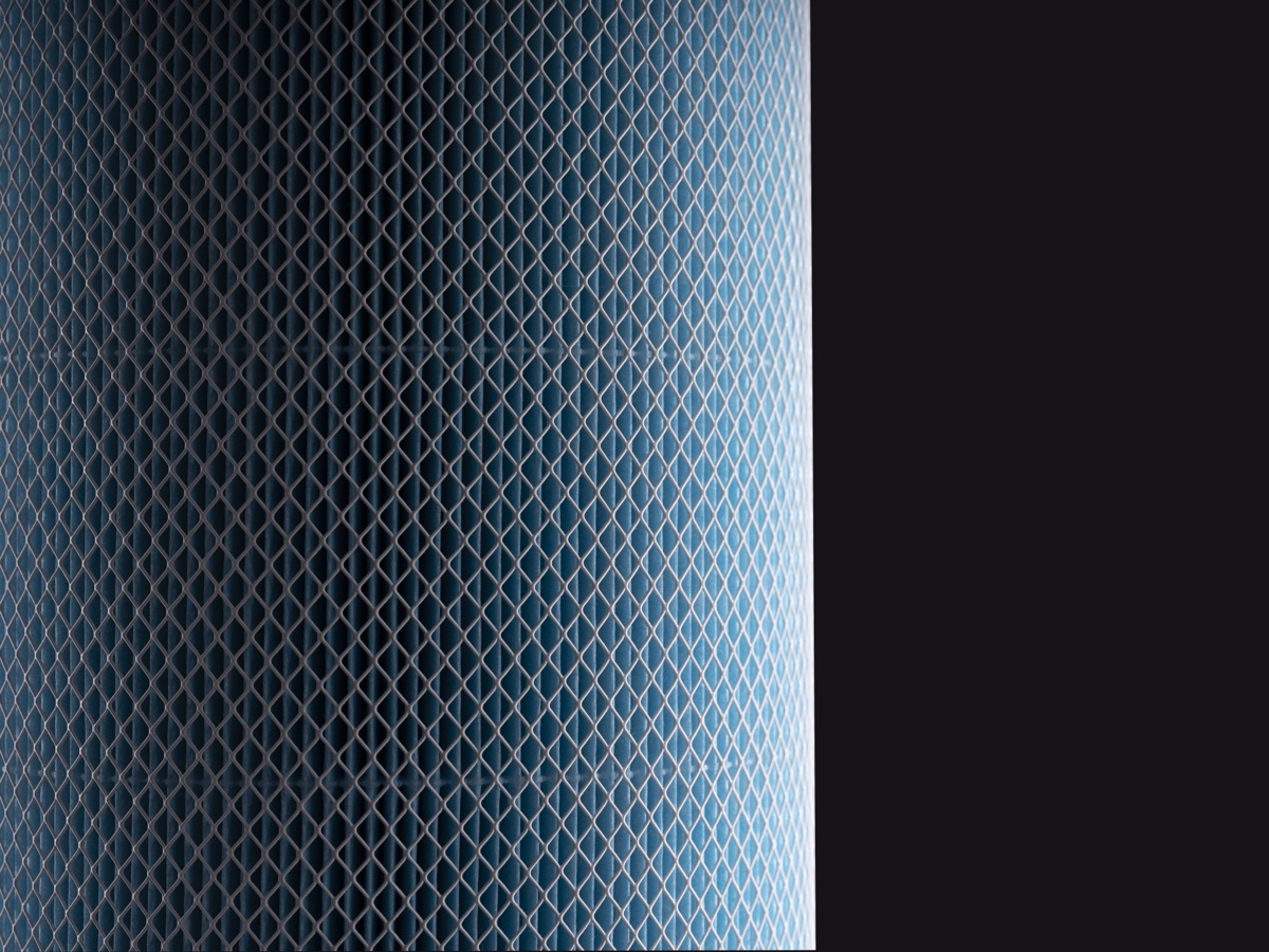 Close-up of the blue mesh surface of a MedicAir Pro cylindrical filter against a black background