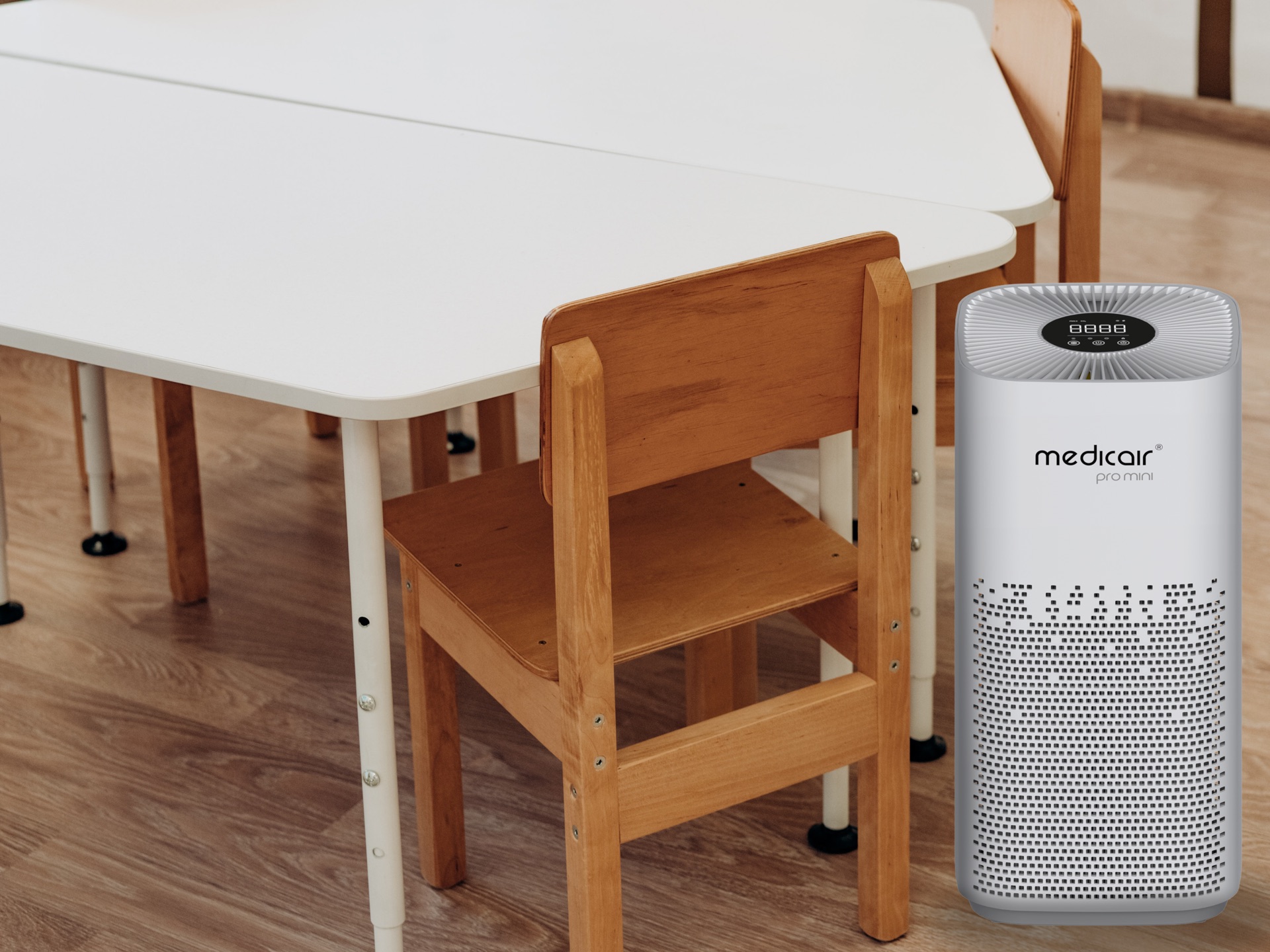 MedicAir Pro Mini air purifier next to small wooden chairs and white tables in a nursery classroom