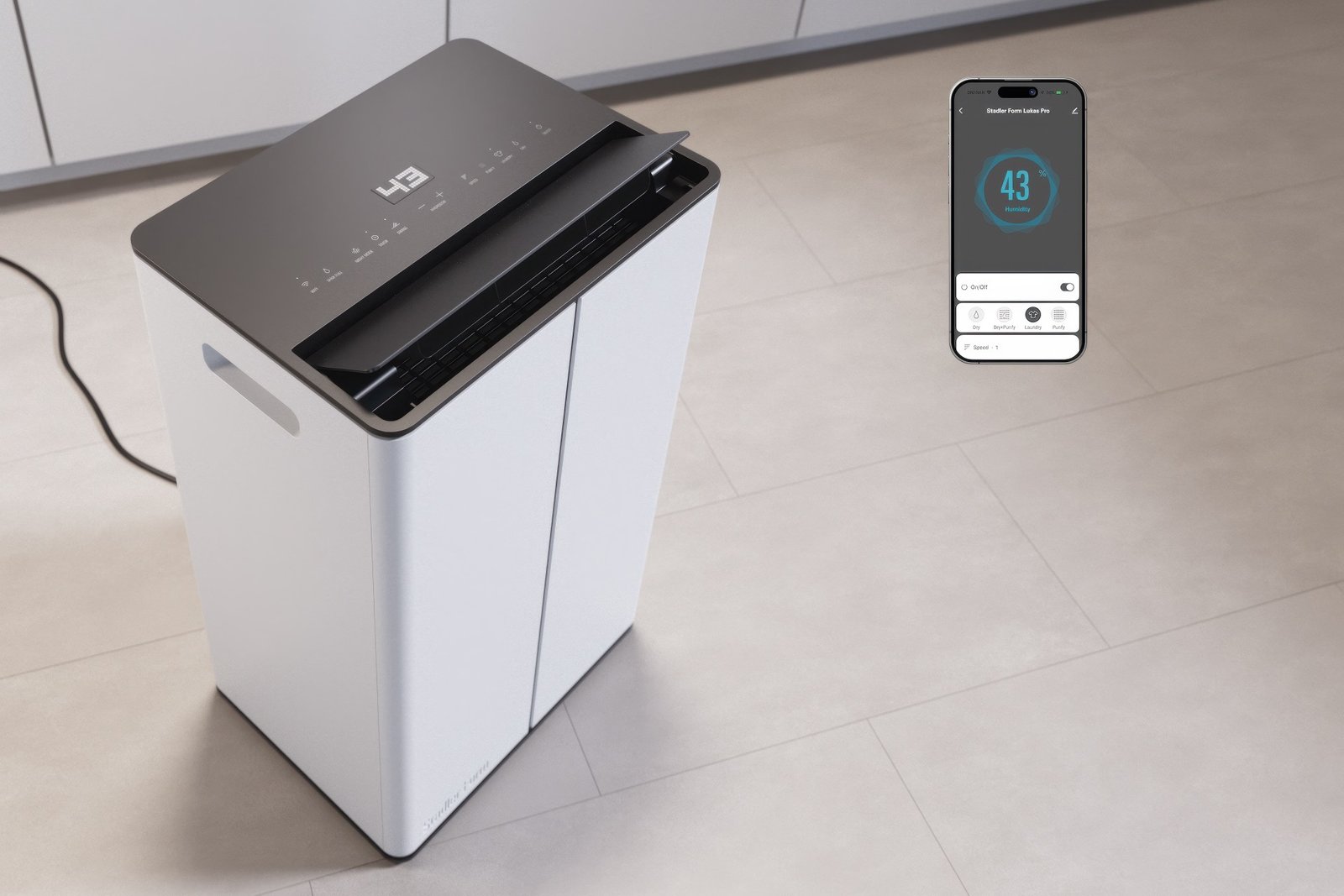 Stadler Form Lukas Pro dehumidifier with its touch panel and the Stadler Form app both reading 43% humidity